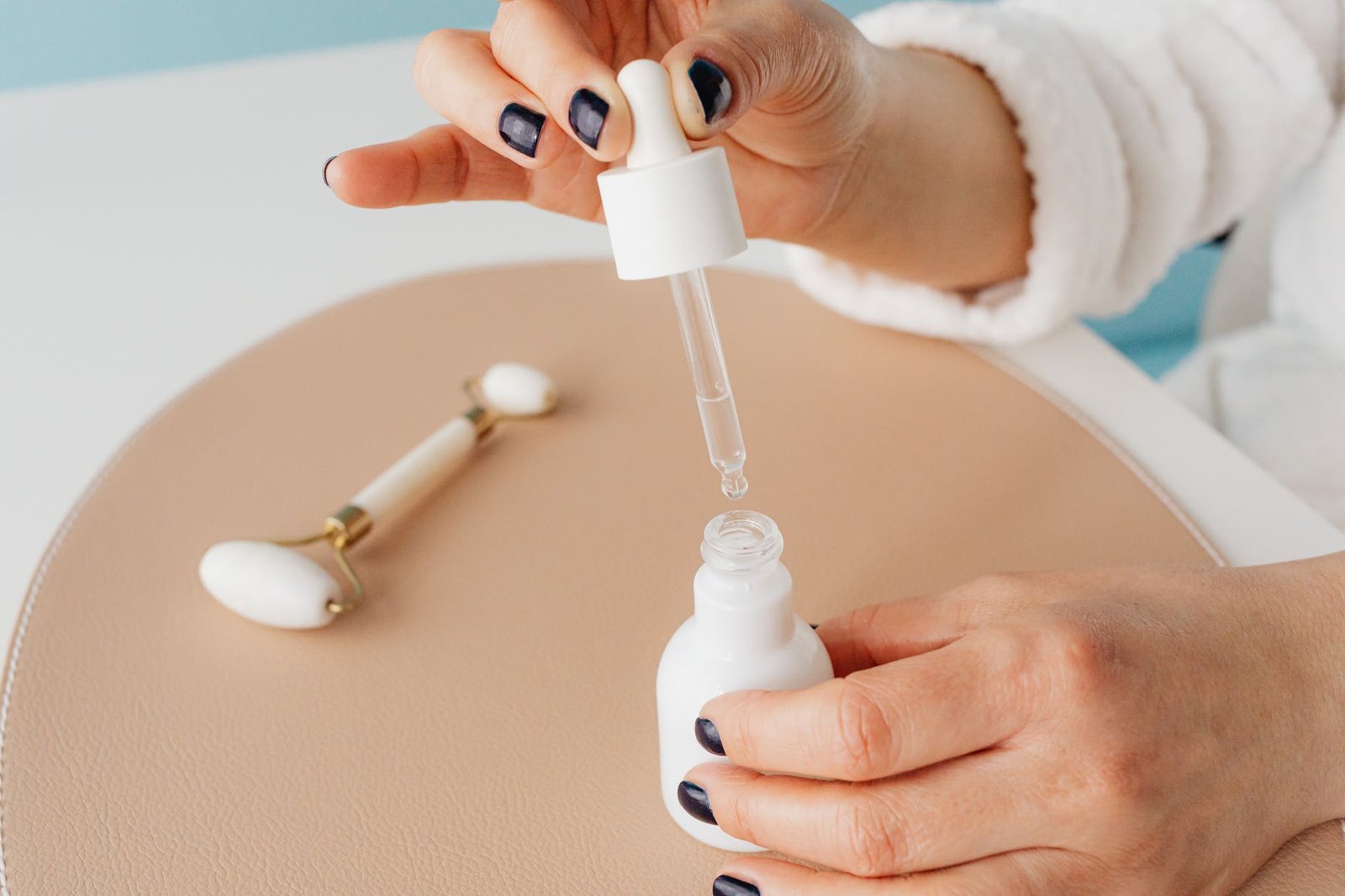 close up of woman holding a pipette with cosmetic product